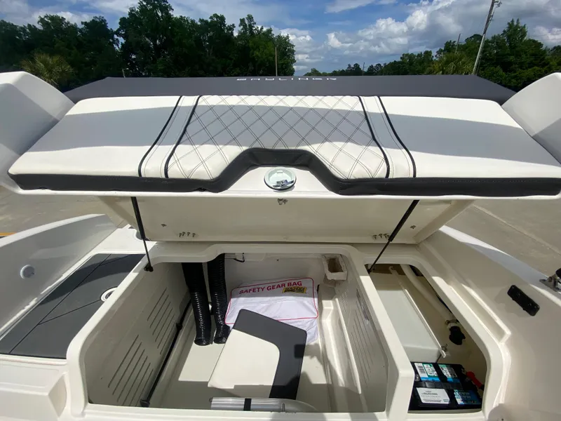 Slide: The Image of 2022 Bayliner DX2000 boat storage compartment with safety gear bag. - 24