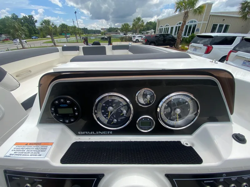Slide: The Image of 2022 Bayliner DX2000 boat dashboard with gauges and controls. - 17