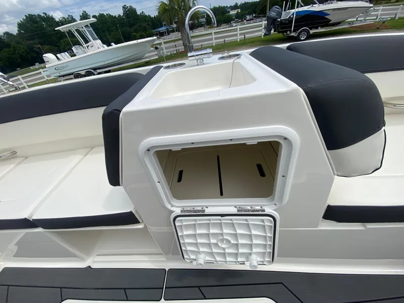 Slide: The Image of 2022 Bayliner DX2000 boat with open storage compartment and sink. - 20