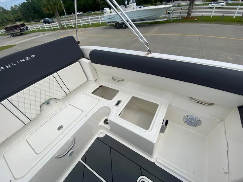 Slide: The Image of 2022 Bayliner DX2000 boat interior with storage compartments and seating. - 22