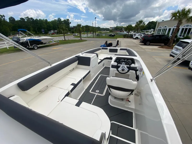Slide: The Image of 2022 Bayliner DX2000 boat interior with seating and steering wheel. - 12