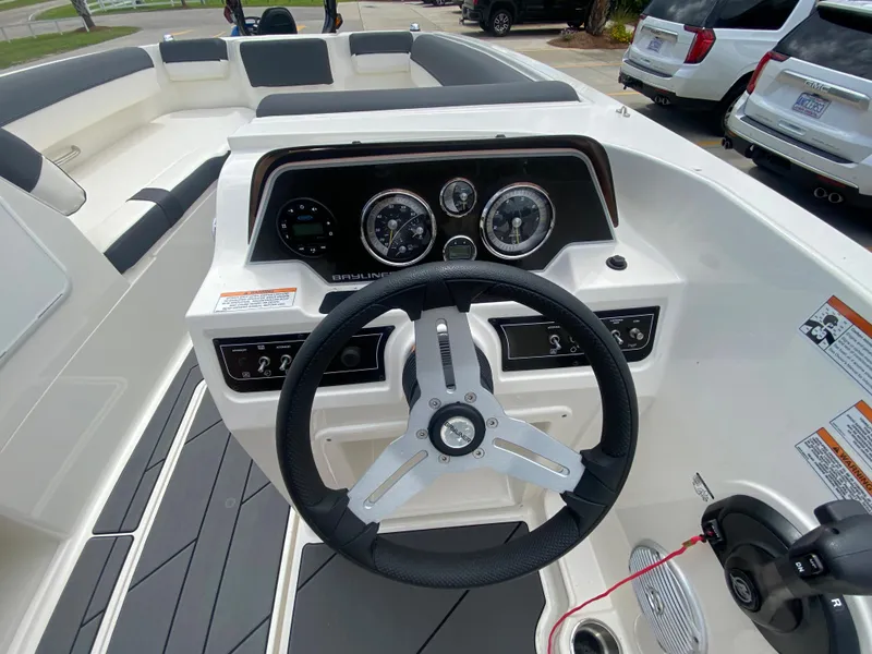 Slide: The Image of 2022 Bayliner DX2000 boat dashboard with steering wheel and instrument panel. - 16