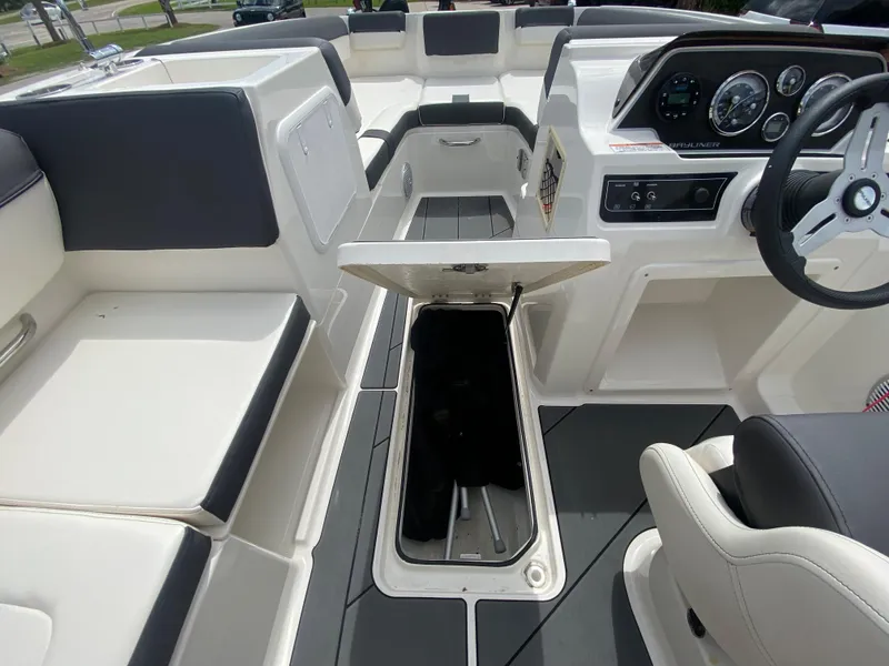 Slide: The Image of 2022 Bayliner DX2000 boat interior with open storage compartment and seating. - 18