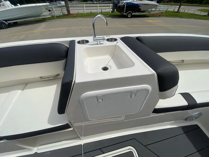 Slide: The Image of 2022 Bayliner DX2000 boat interior with sink and seating area. - 19
