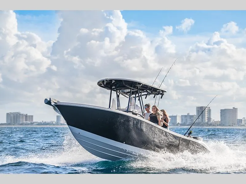 Slide: The Image of 2023 Sea Chaser 24HFC boat cruising on the ocean with city skyline in the background. - 1