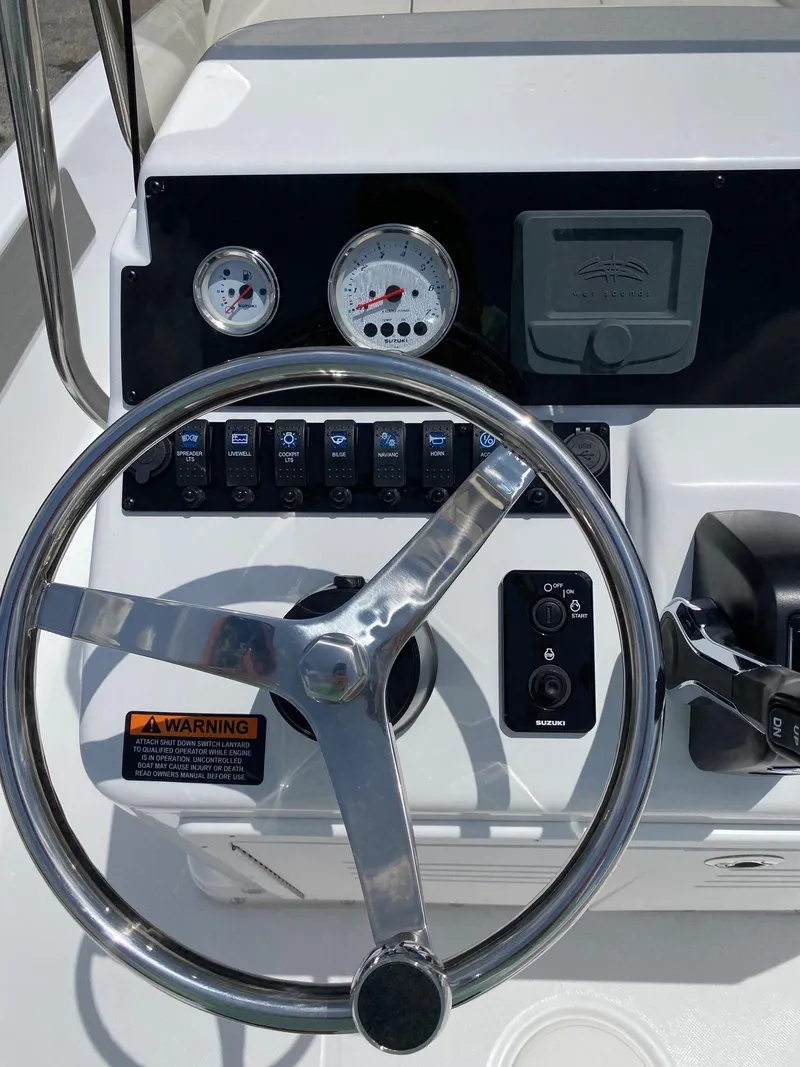 Slide: The Image of Steering console of a 2023 Savannah 190IS boat with gauges and controls. - 10