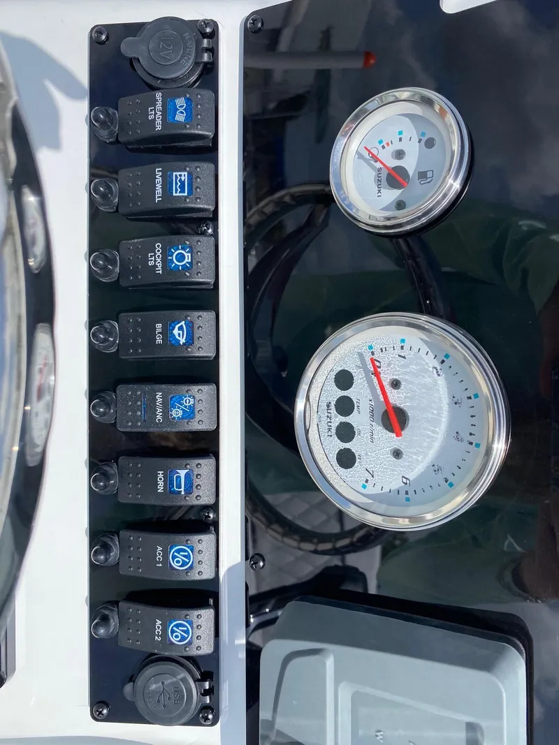 Slide: The Image of Control panel of a 2023 Savannah 190IS boat with switches and gauges. - 11