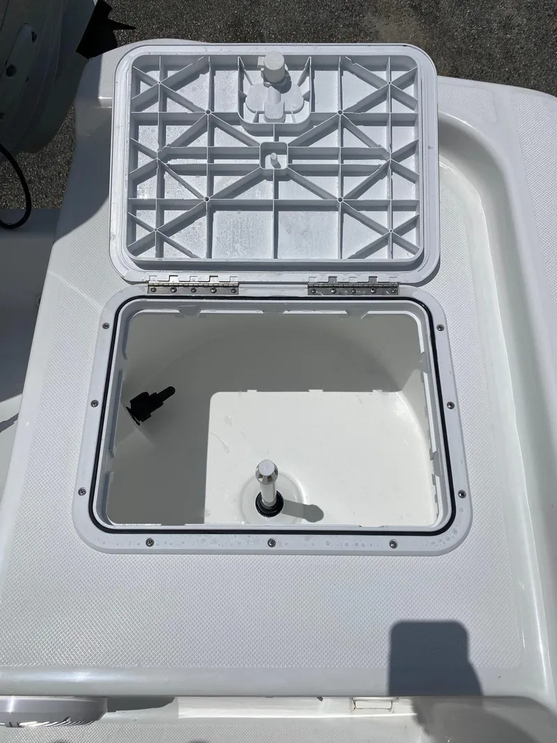 Slide: The Image of 2023 Savannah 190IS boat storage compartment with open lid. - 18