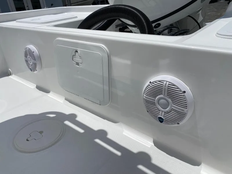 Slide: The Image of 2023 Savannah 190IS boat interior with built-in speakers and storage compartments. - 22