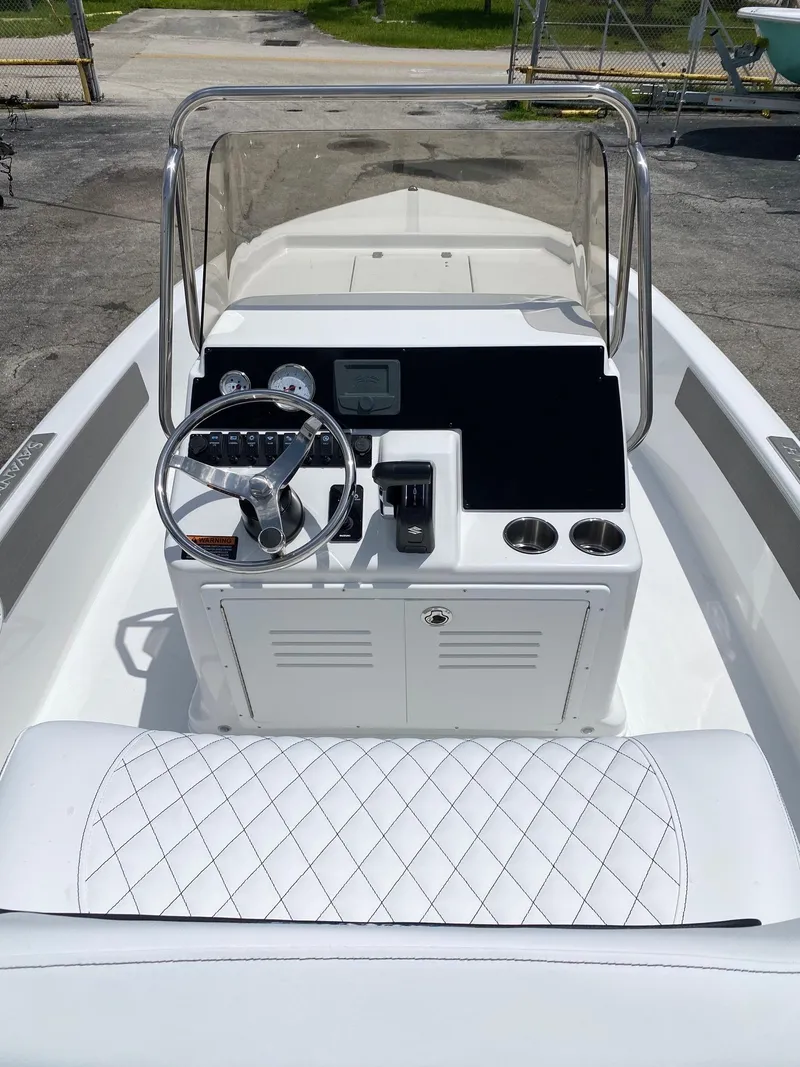 Slide: The Image of 2023 Savannah 190IS boat interior with steering console and cushioned seating. - 5
