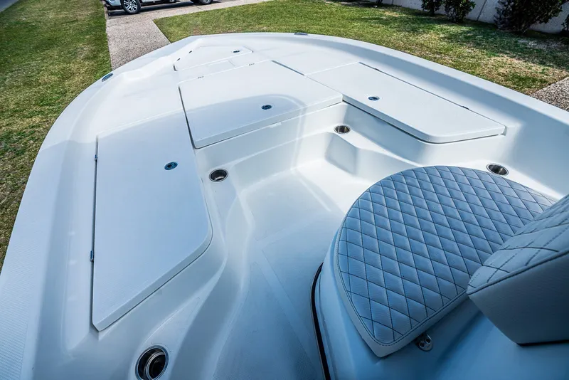 Slide: The Image of 2021 Catalyst 2300 BAY boat interior with cushioned seating and storage compartments. - 11