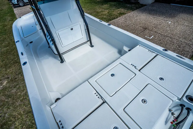 Slide: The Image of 2021 Catalyst 2300 BAY boat interior with storage compartments and seating. - 6