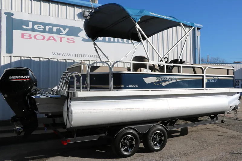 Slide: The Image of 2021 Ranger RP200C pontoon boat on trailer at Jerry Whittle Boats dealership. - 1
