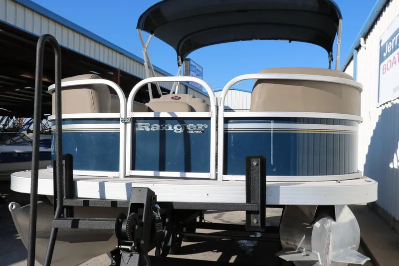 Slide: The Image of 2021 Ranger RP200C pontoon boat in storage, blue and white exterior. - 11