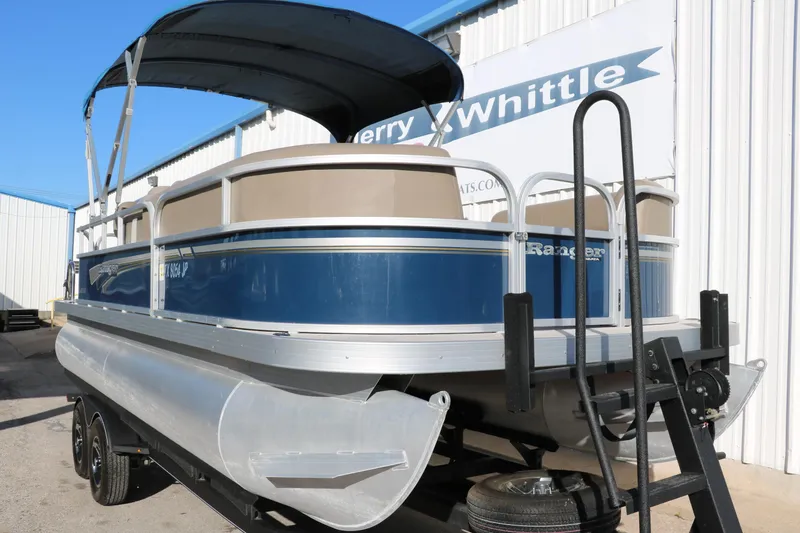 Slide: The Image of 2021 Ranger RP200C pontoon boat on a trailer. - 13