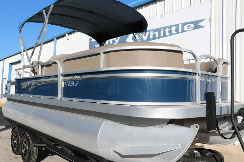 Slide: The Image of 2021 Ranger RP200C pontoon boat with blue exterior and canopy. - 14