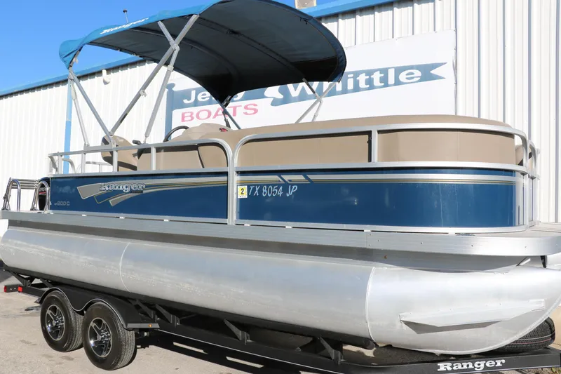 Slide: The Image of 2021 Ranger RP200C pontoon boat on trailer with blue canopy. - 15