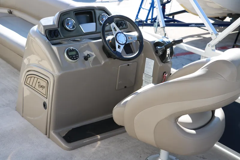 Slide: The Image of 2021 Ranger RP200C boat console with steering wheel and control panel. - 26