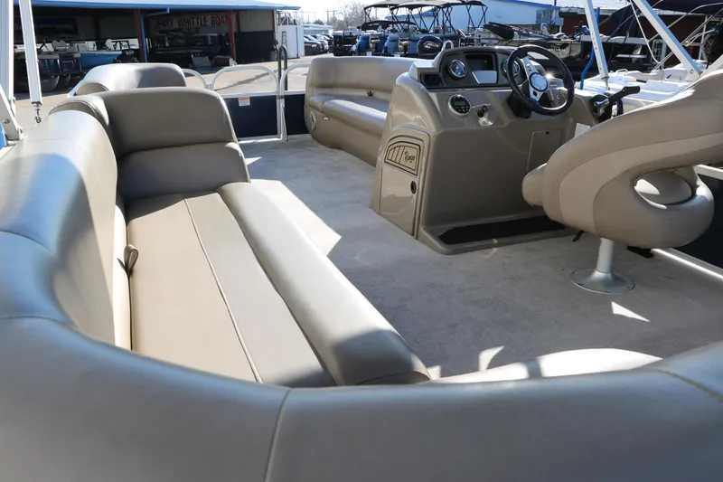 Slide: The Image of 2021 Ranger RP200C pontoon boat interior with beige seating and helm station. - 27