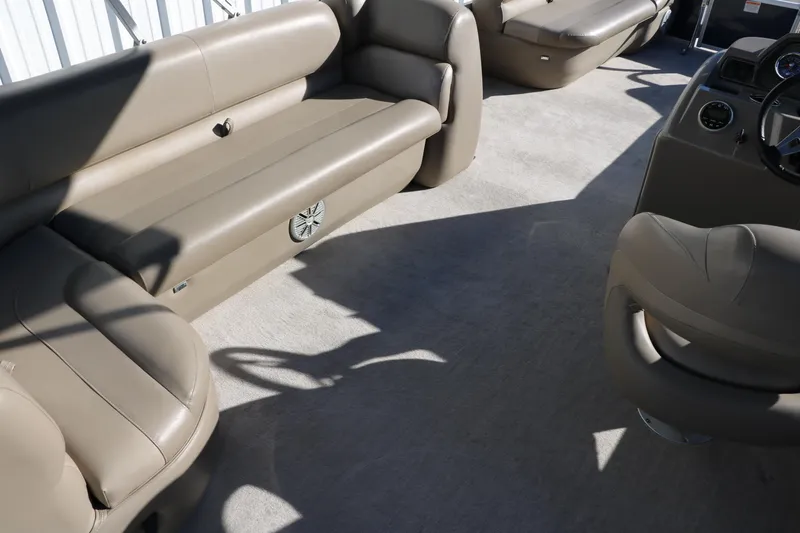 Slide: The Image of 2021 Ranger RP200C boat interior with beige seating and steering console. - 33