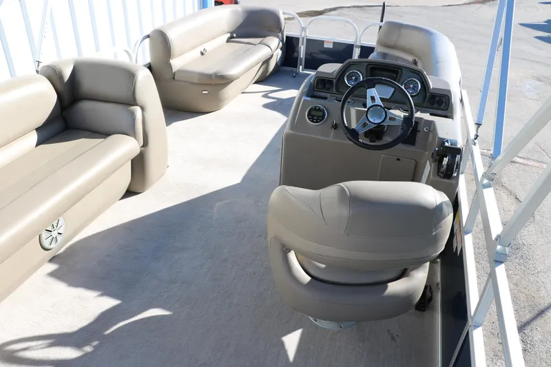 Slide: The Image of 2021 Ranger RP200C pontoon boat interior with beige seating and steering console. - 35