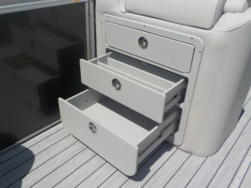 Slide: The Image of Open storage drawers on a 2023 SunCatcher Elite 326SS boat. - 10