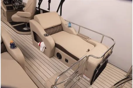 Slide: The Image of 2023 SunCatcher Elite 326SS boat interior with beige seating and cup holders. - 17