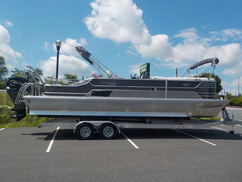 Slide: The Image of 2023 SunCatcher Elite 326SS pontoon boat on trailer in parking lot. - 18