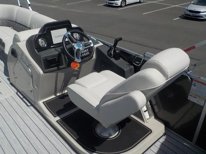 Slide: The Image of 2023 SunCatcher Elite 326SS boat helm with Garmin navigation system and plush captain's chair. - 21