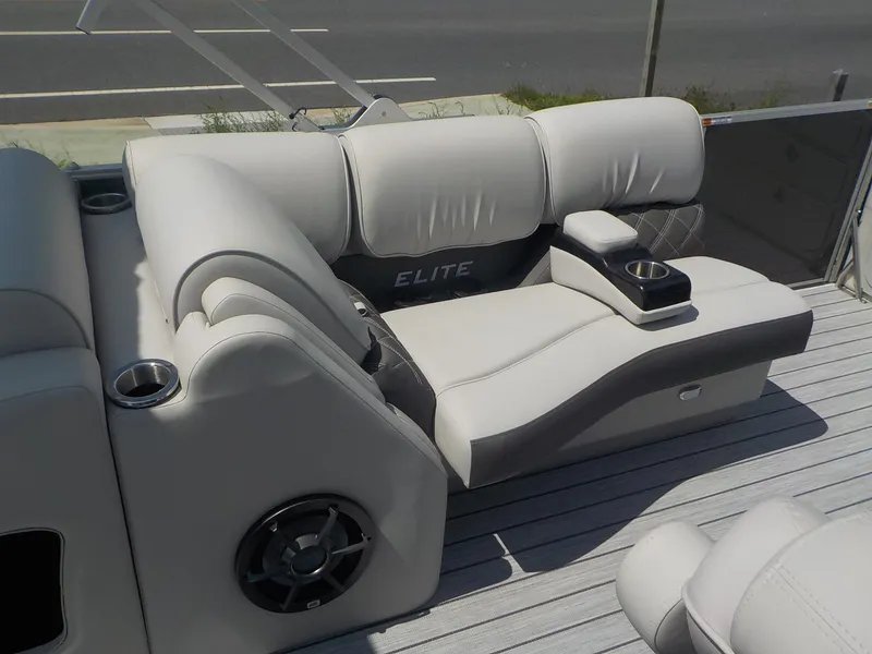 Slide: The Image of SunCatcher Elite 326SS 2023 boat interior with luxurious seating and cup holders. - 7