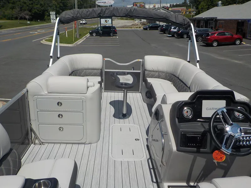 Slide: The Image of 2023 SunCatcher Elite 326SS pontoon boat interior with plush seating and Garmin navigation system. - 9