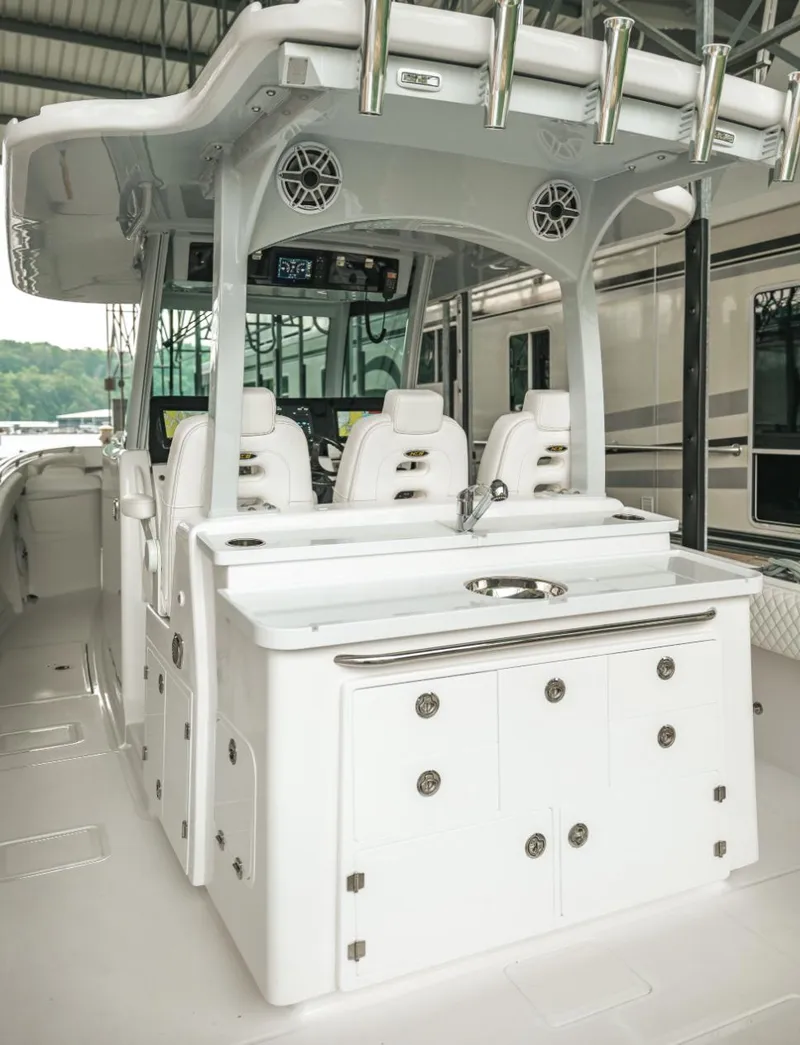 Slide: The Image of 2023 HCB 39 Speciale boat interior with white seating and storage cabinets. - 24
