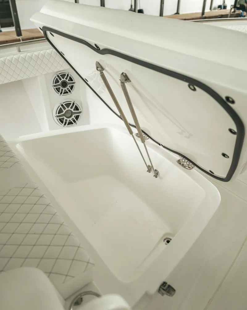 Slide: The Image of 2023 HCB 39 Speciale boat storage compartment with open lid and speakers. - 30
