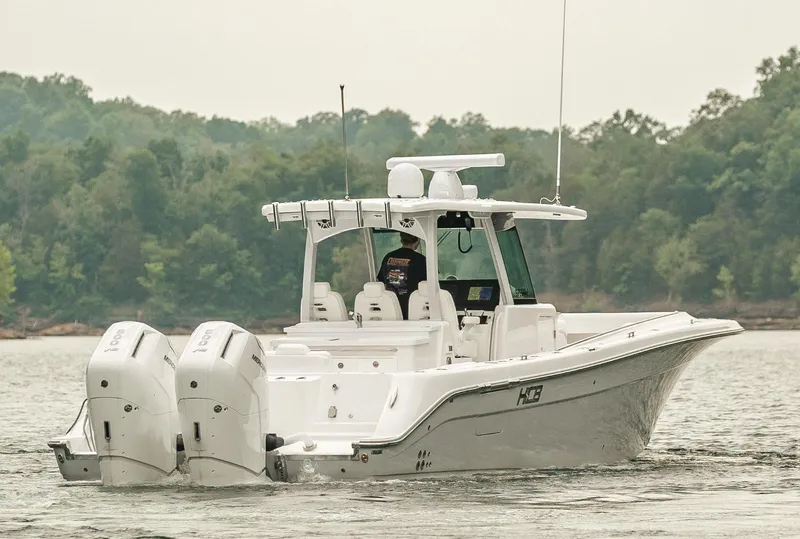 Slide: The Image of 2023 HCB 39 Speciale boat with dual outboard engines on a lake. - 5