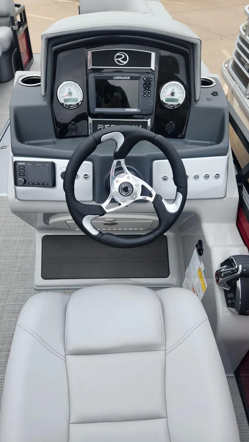 Slide: The Image of 2023 Regency 250 DL3 boat dashboard with steering wheel and control panel. - 3