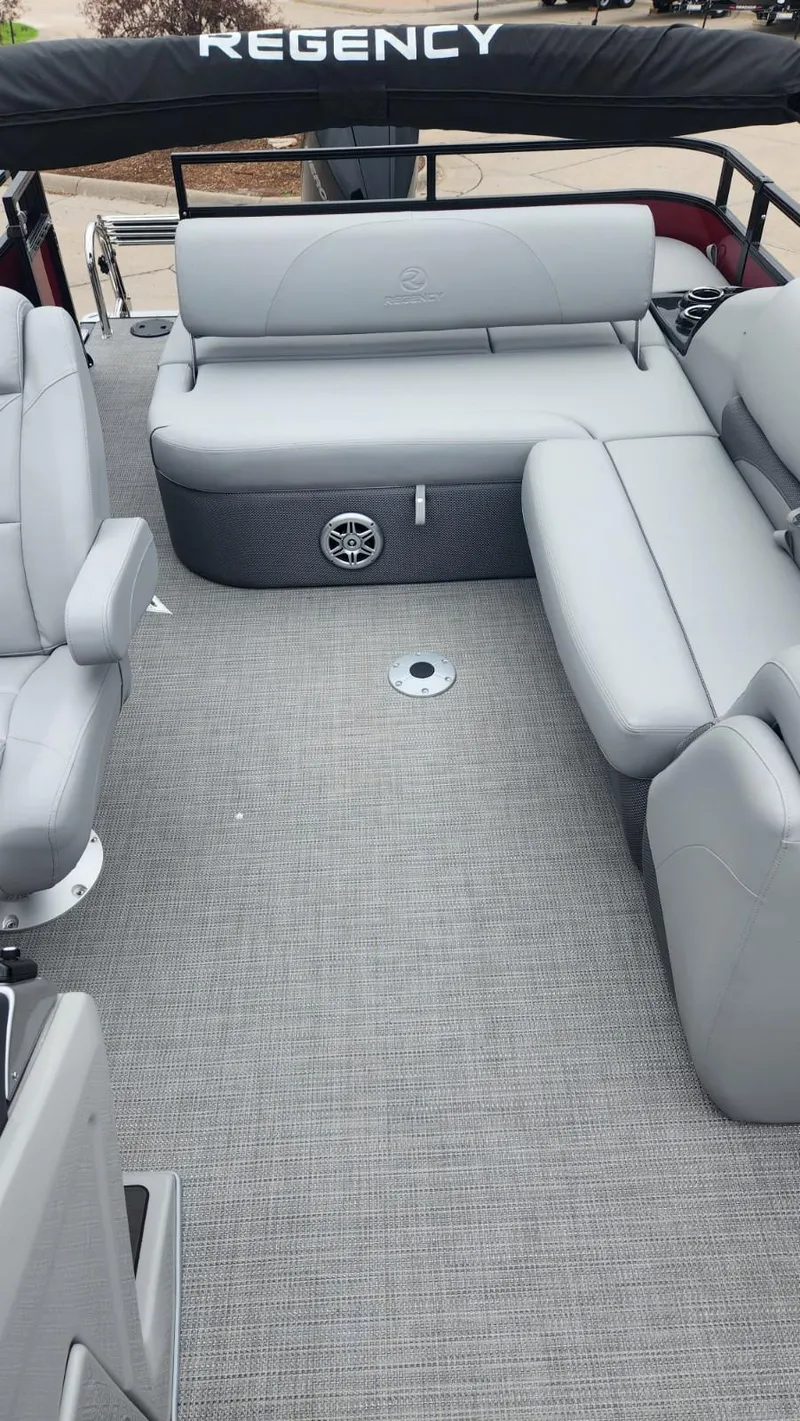 Slide: The Image of 2023 Regency 250 DL3 pontoon boat with spacious seating and modern design. - 4