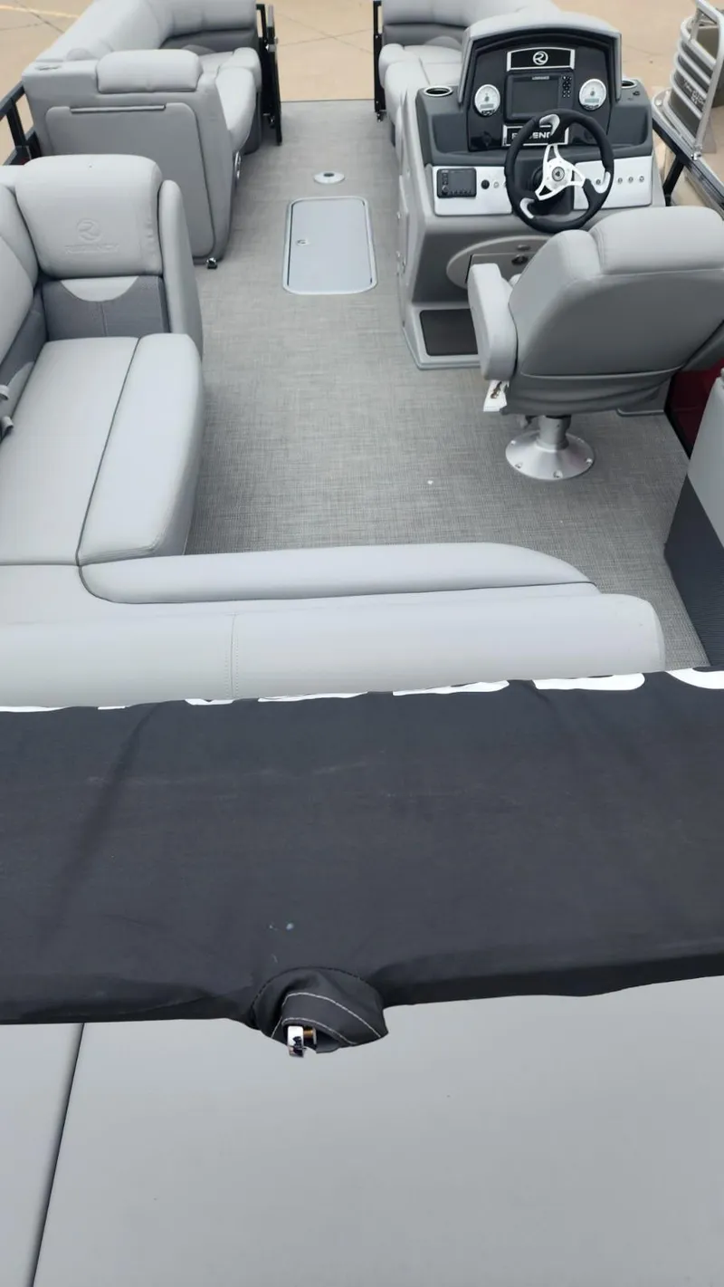 Slide: The Image of 2023 Regency 250 DL3 pontoon boat interior with gray seating and modern dashboard. - 5