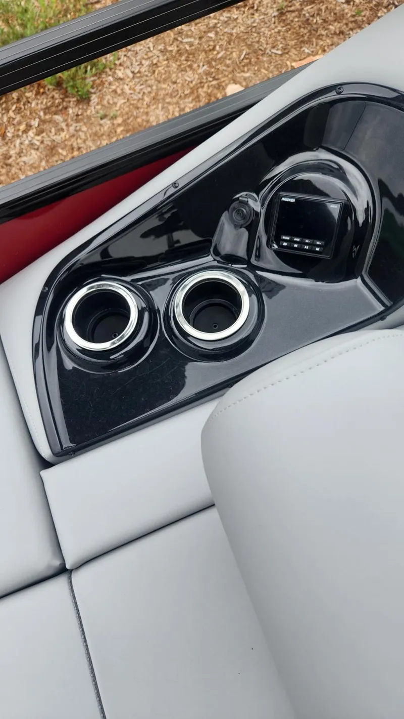 Slide: The Image of Close-up of the 2023 Regency 250 DL3 boat's cup holders and seating area. - 6