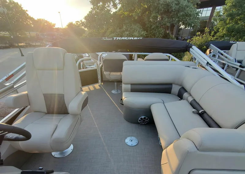 Slide: The Image of 2023 Sun Tracker SportFish 22 XP3 pontoon boat interior with beige seating. - 3