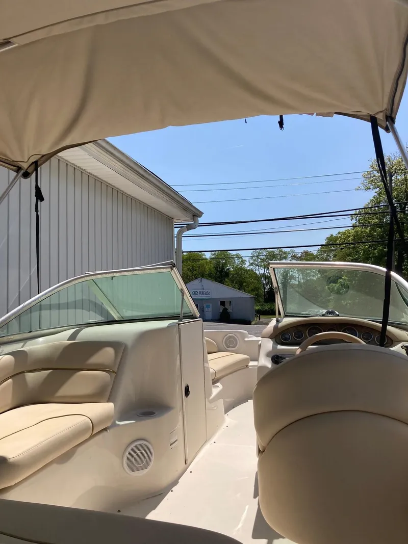 Slide: The Image of 2001 Sea Ray 190 Sundeck boat interior with beige seating and canopy. - 3