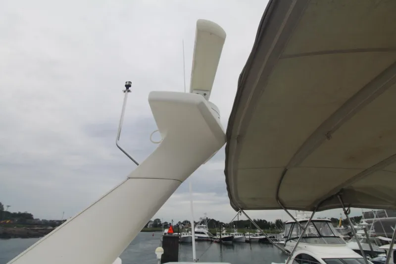 Slide: The Image of 2000 Silverton 392 Motor Yacht radar and canopy, docked in a marina. - 13