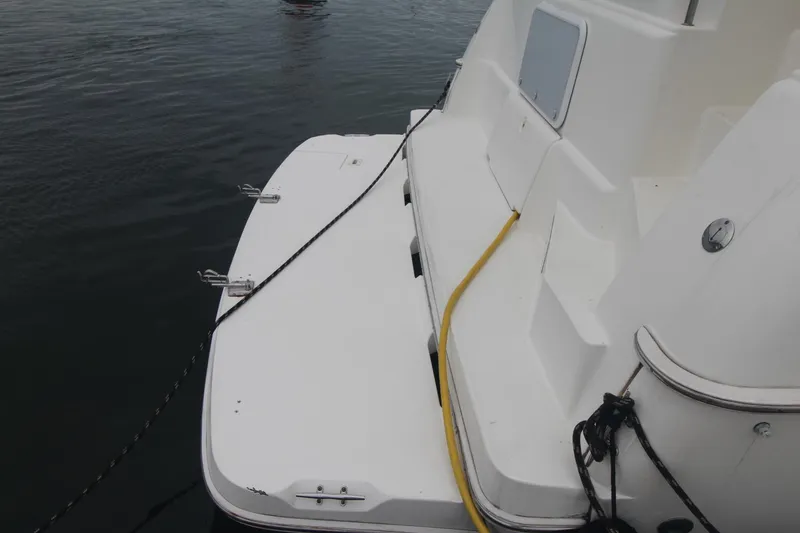 Slide: The Image of 2000 Silverton 392 Motor Yacht stern view with dock lines and water hose. - 16