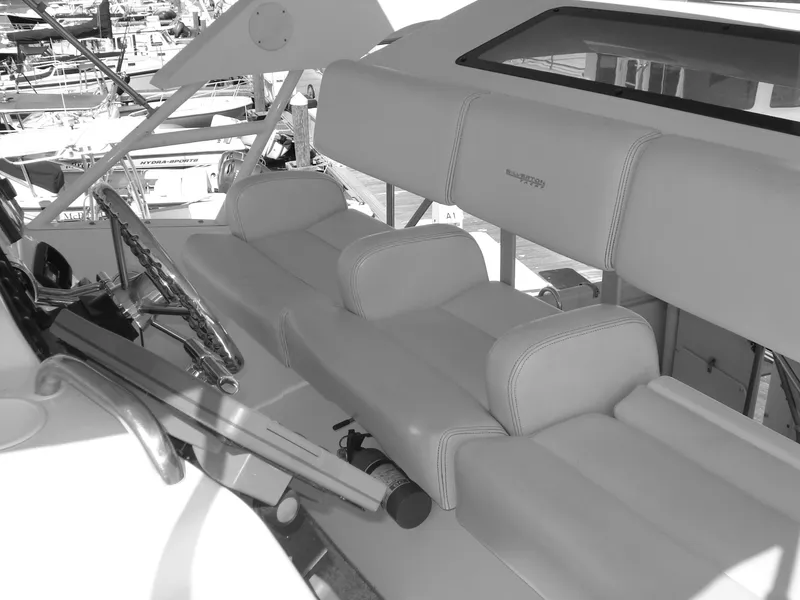 Slide: The Image of 2000 Silverton 392 Motor Yacht interior with steering wheel and cushioned seating. - 19