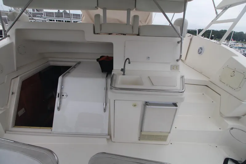 Slide: The Image of 2000 Silverton 392 Motor Yacht deck with sink and seating area. - 20