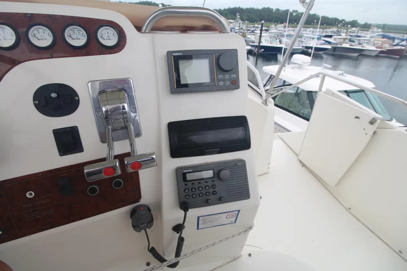 Slide: The Image of 2000 Silverton 392 Motor Yacht helm with controls and gauges at marina. - 25