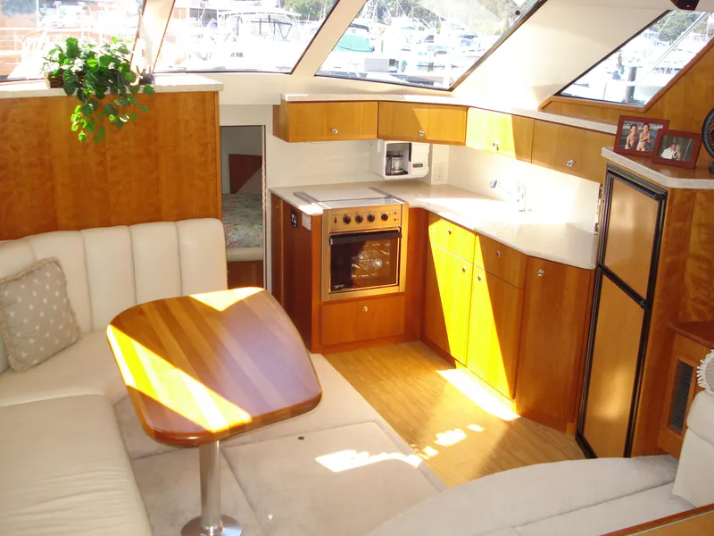 Slide: The Image of Interior of 2000 Silverton 392 Motor Yacht with kitchen and seating area. - 27
