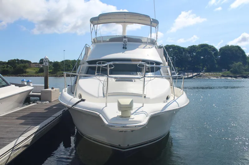 Slide: The Image of 2000 Silverton 392 Motor Yacht docked at marina under clear blue sky. - 3