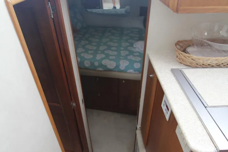 Slide: The Image of Interior view of 2000 Silverton 392 Motor Yacht cabin with bed and kitchenette. - 35