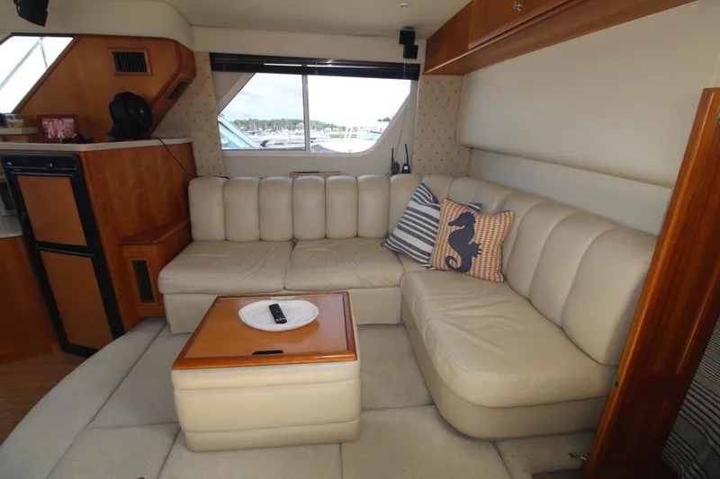 Slide: The Image of Interior of 2000 Silverton 392 Motor Yacht with beige seating and nautical-themed decor. - 37