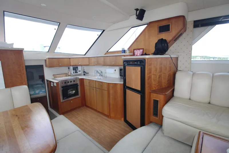 Slide: The Image of Interior of 2000 Silverton 392 Motor Yacht with kitchen and seating area. - 38